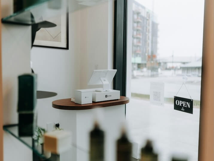 a modern retail display with window and open sign