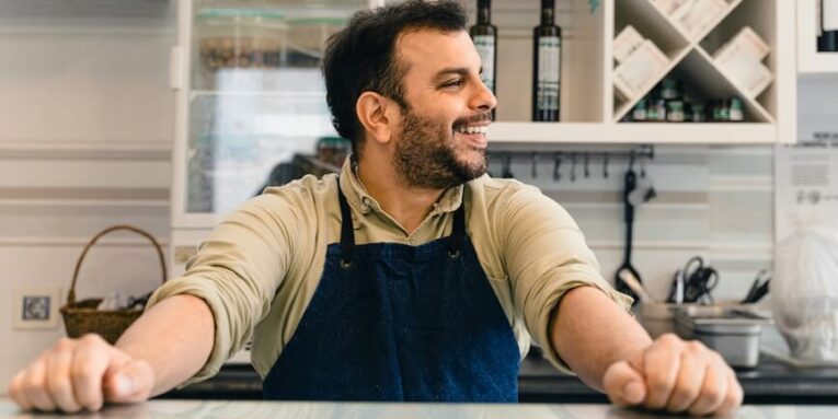 a smiling barista is ready for customers FEATURED IMAGE