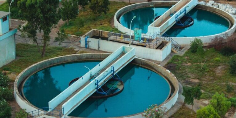 Drone shot of an advanced water purification plant surrounded by trees FEATURED IMAGE