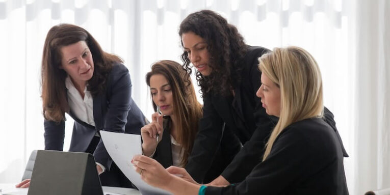 women in blazers having a meeting in an office FEATURED IMAGE