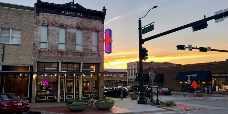 brown concrete building in small town FEATURED IMAGE