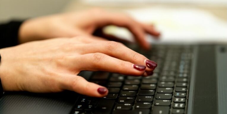 persons hand on black laptop computer FEATURED IMAGE
