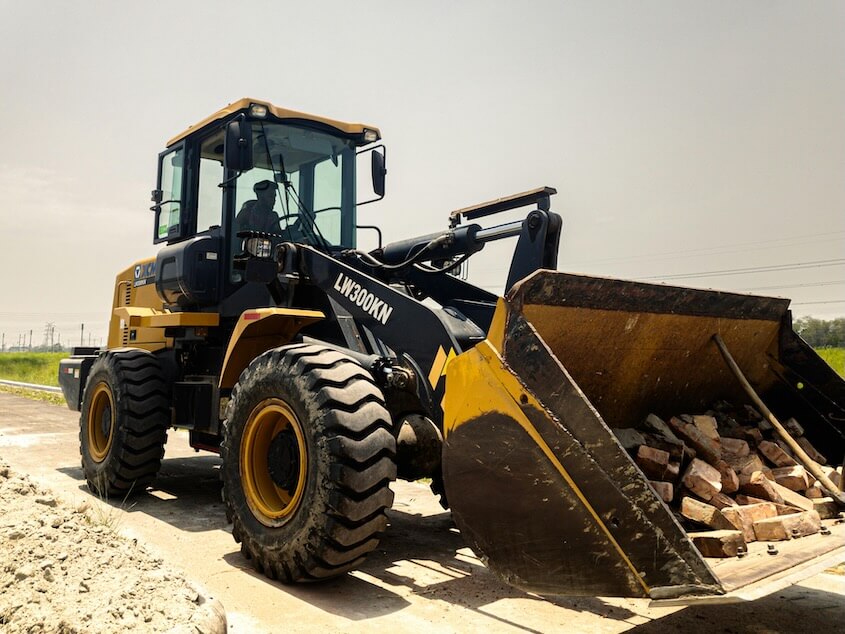 Front loader with bricks in bucket