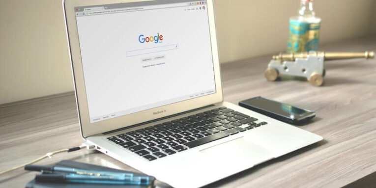 Macbook Air on Grey Wooden Table FEATURED IMAGE