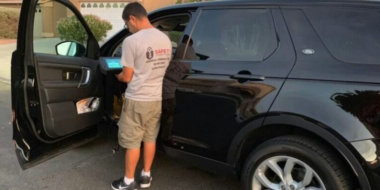 a man opening the door of a black suv FEATURED IMAGE