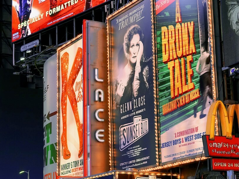 a bunch of billboards that are on the side of a building