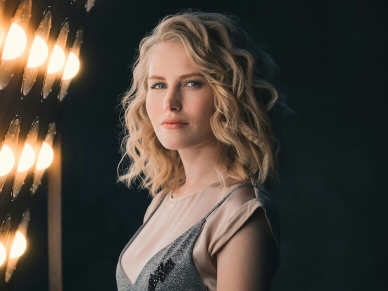 woman standing beside lights