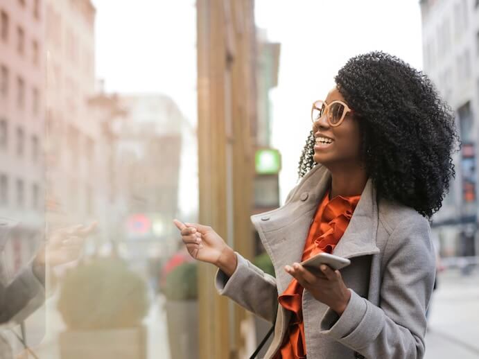Happy black woman laughing on street