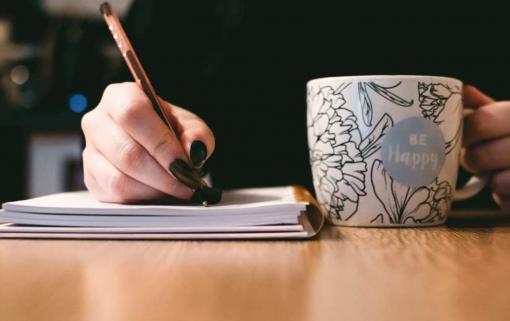 Person Holding White Ceramci Be Happy Painted Mug
