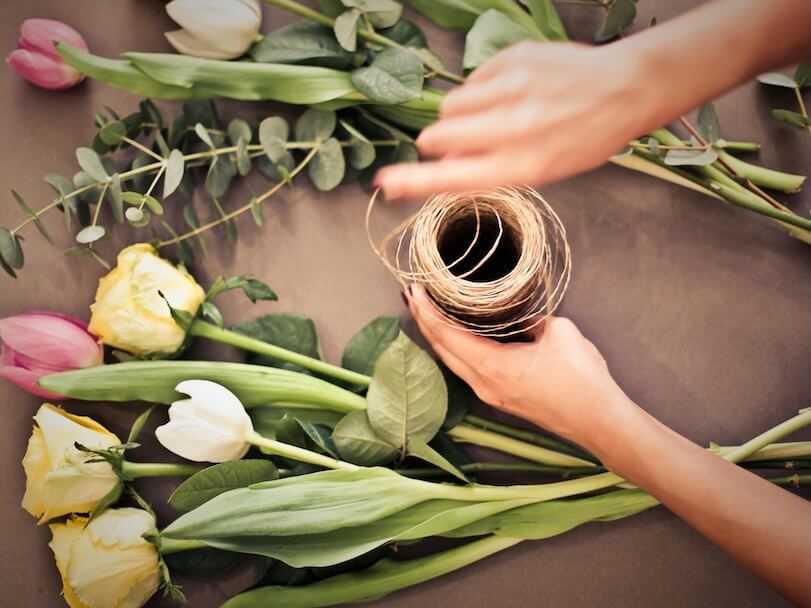 Person's Hand Near Flowers
