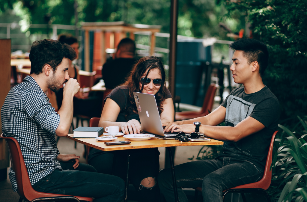 photo of three person sitting and talking