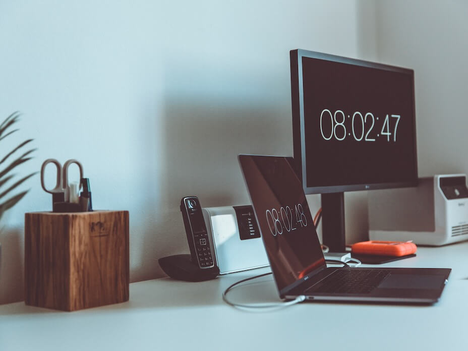 turned on computer monitor and laptop with 080247 on screens