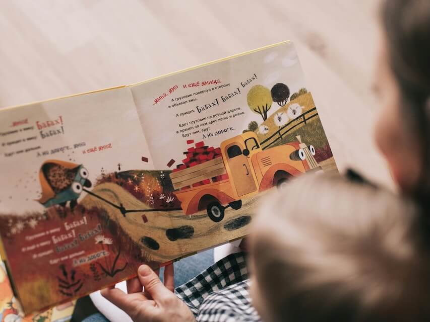 Woman Reading Book to Toddler