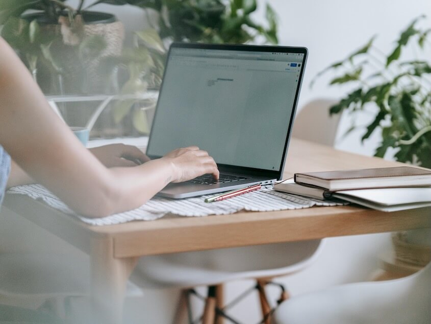 Woman working on laptop at home
