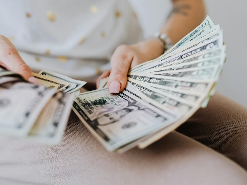 Person Holding Fan of Us Dollar Bills