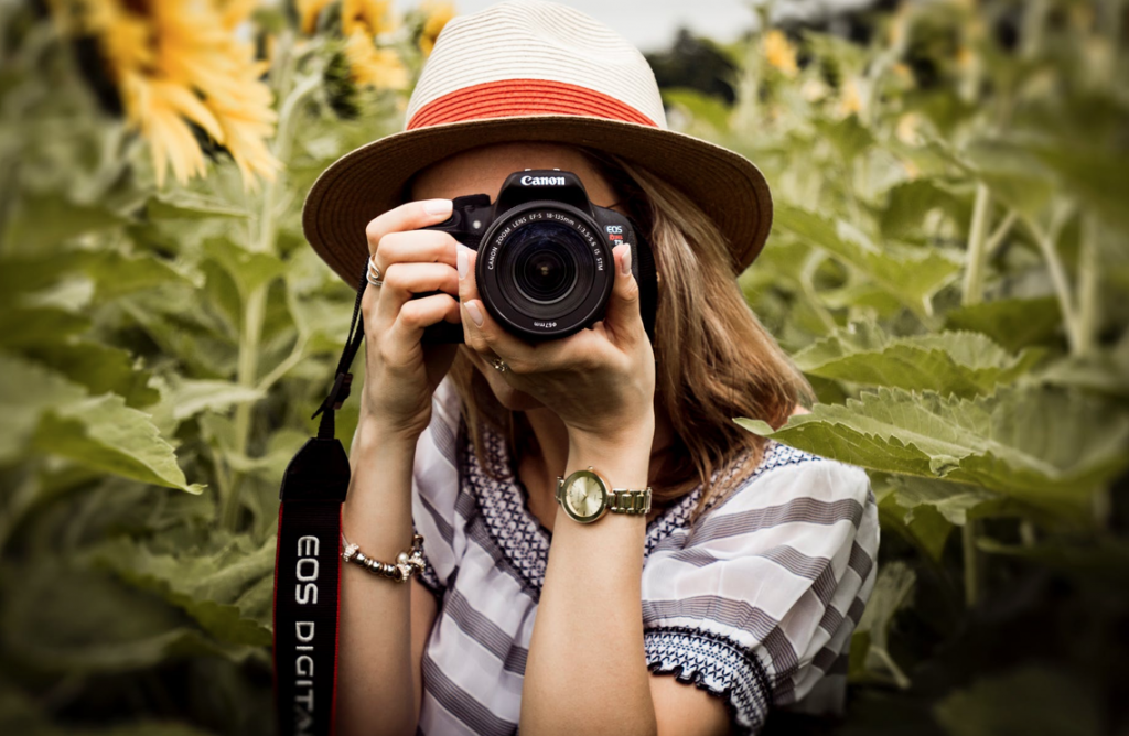 Selective Focus Photography of Woman Holding Dslr Camera