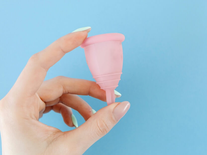 A Hand Holding a Menstrual Cup