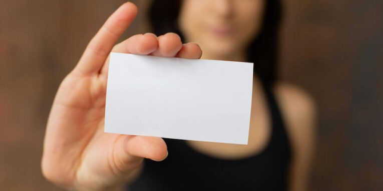Crop woman showing blank business card feature