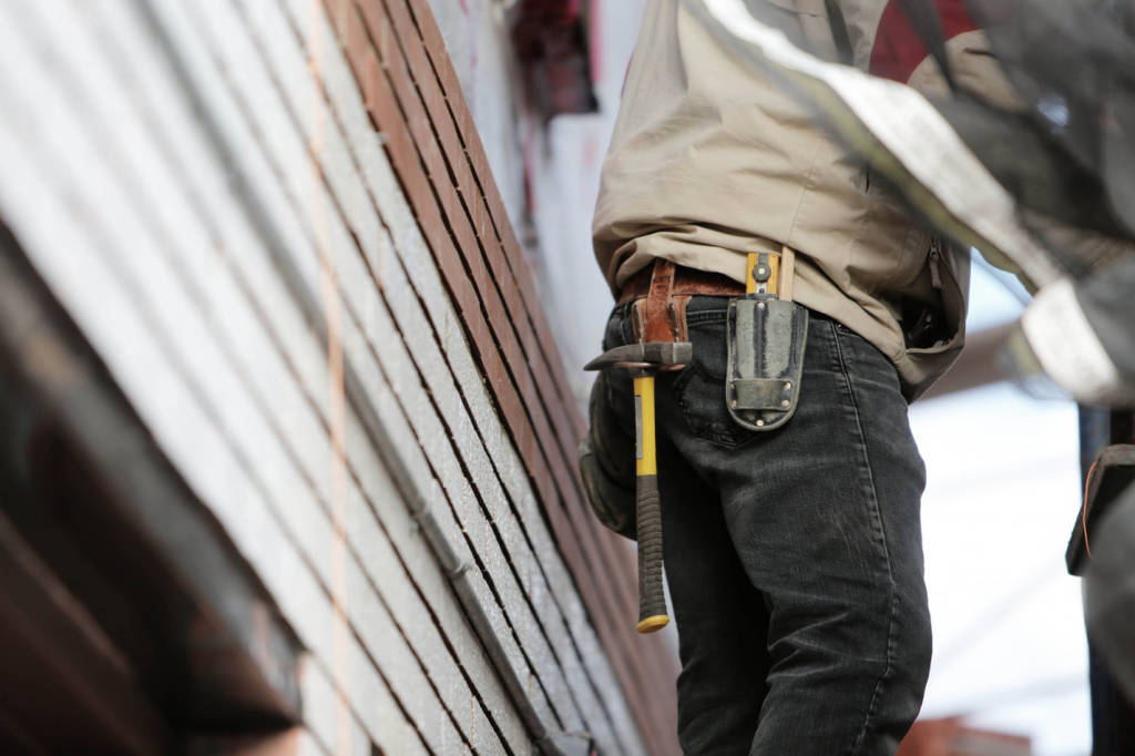 Man Wearing Black Denim Pants With Carrying Hammer on Holster