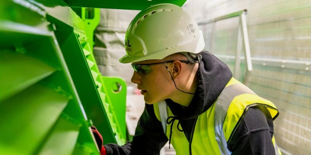 Man with White Helmet in Factory Featured