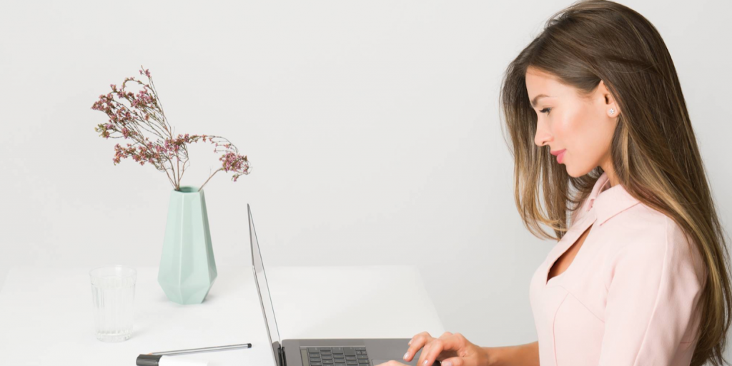 Woman in Pink Dress Using Laptop Computer FEATURED IMAGE