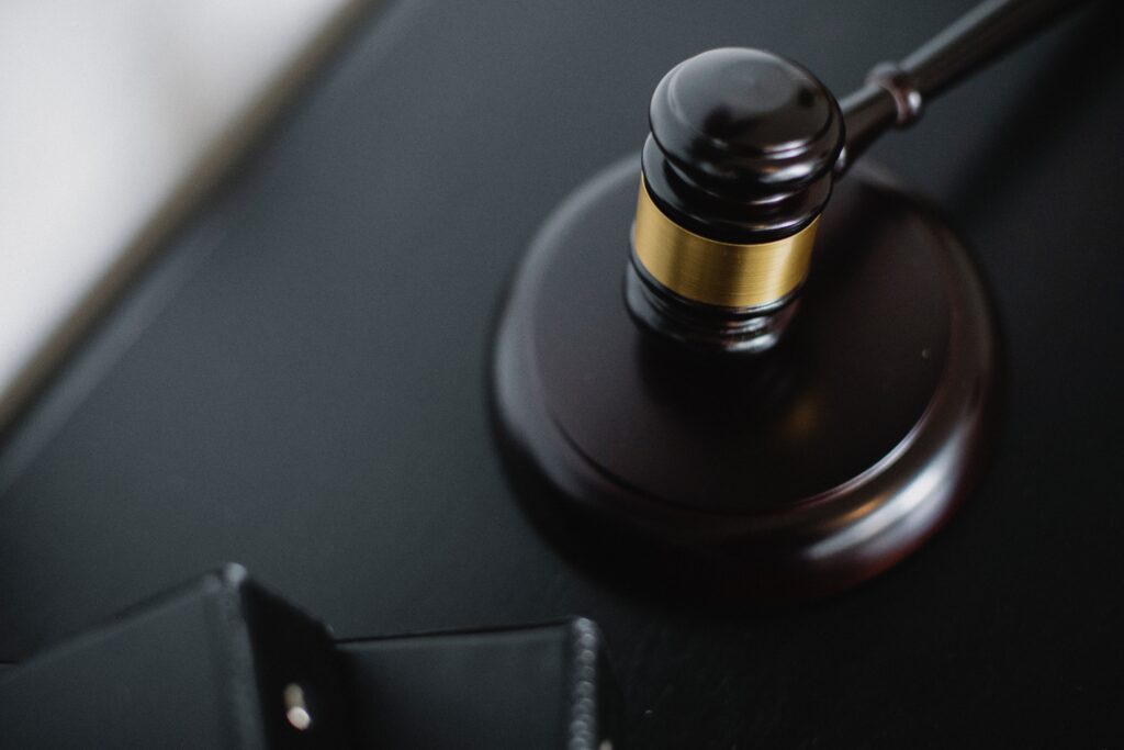 Close-up of a wooden gavel on a desk, symbolizing justice and legal authority