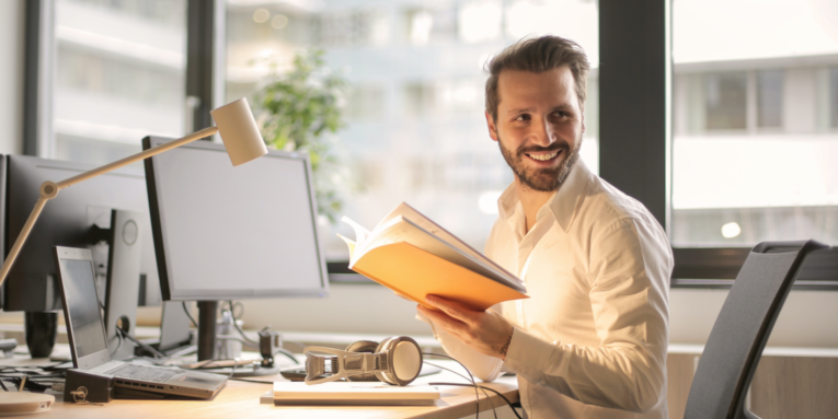 Photo of Man Holding a Book FEATURED IMAGE