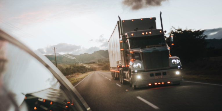 red truck on road during daytime FEATURED IMAGE