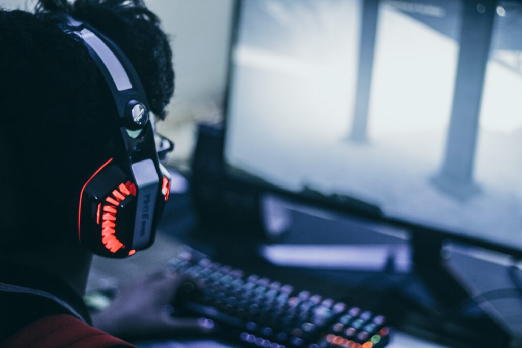 person wearing orange and black headphones 