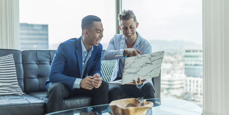 two men in suit sitting on sofa FEATURED IMAGE