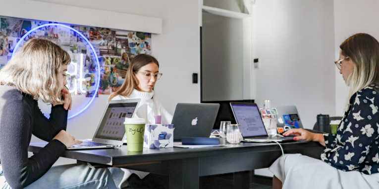 3 women sitting on chair in front of table with laptop computers FEATURED IMAGE
