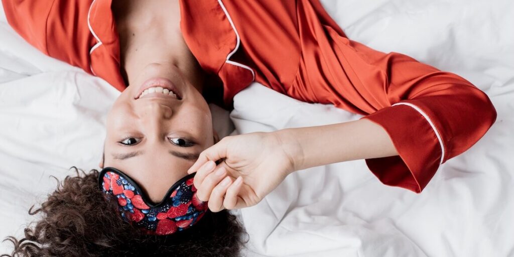 a woman lying on a bed smiling
