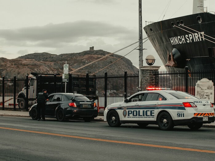 white and blue police car on the road