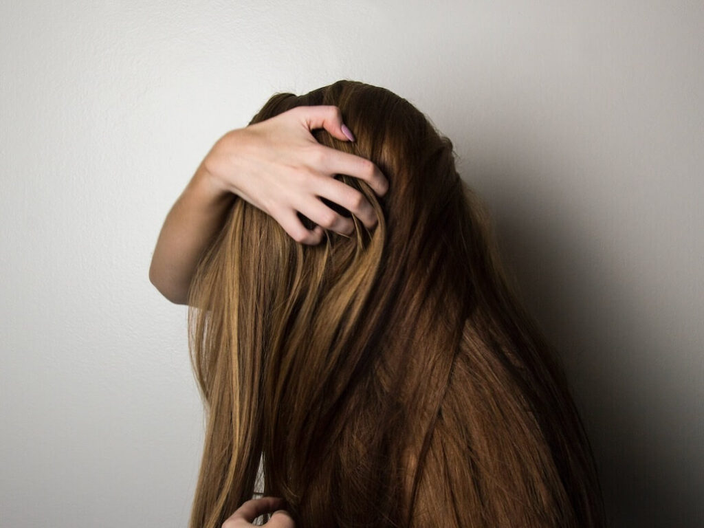 woman holding her hair back