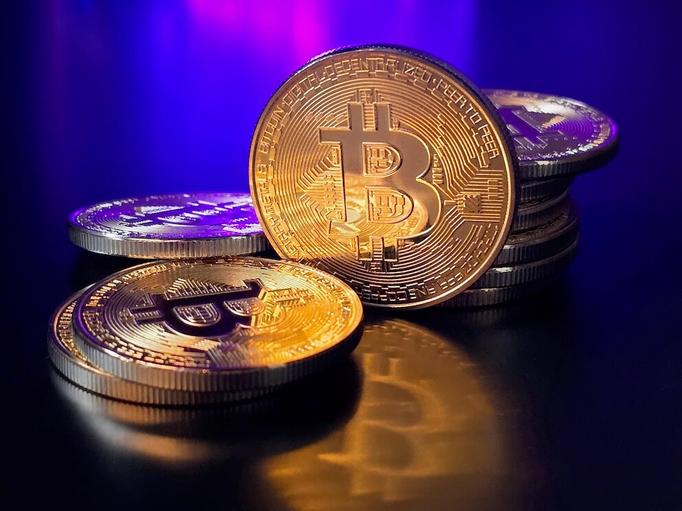 a pile of bitcoins sitting on top of a table