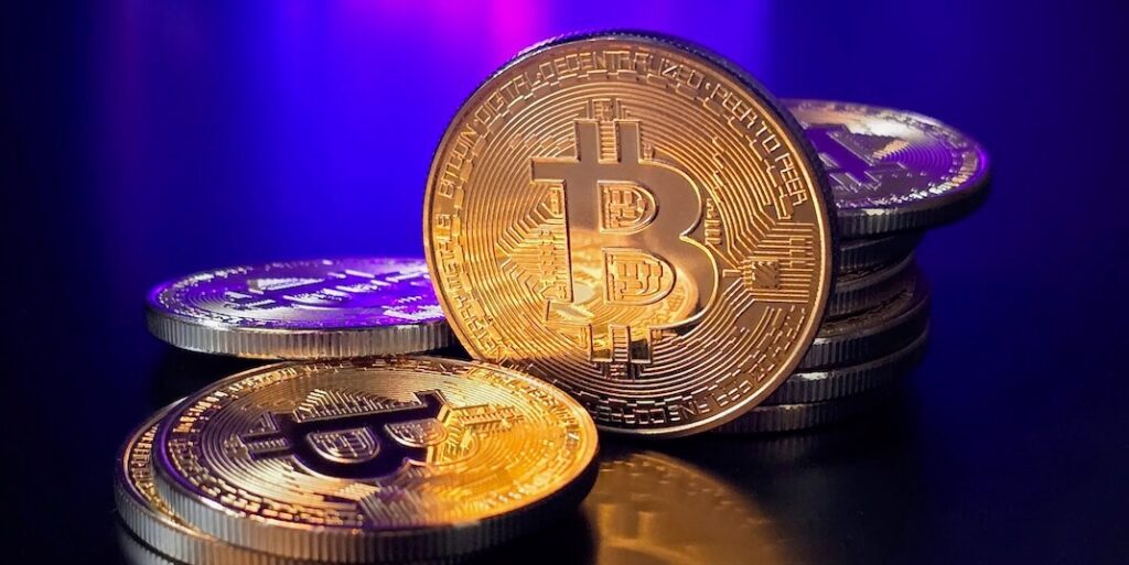 a pile of bitcoins sitting on top of a table | EPN Feature