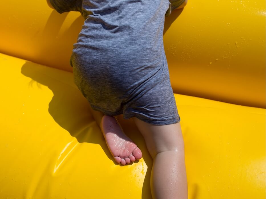 person crawling on inflatable floater