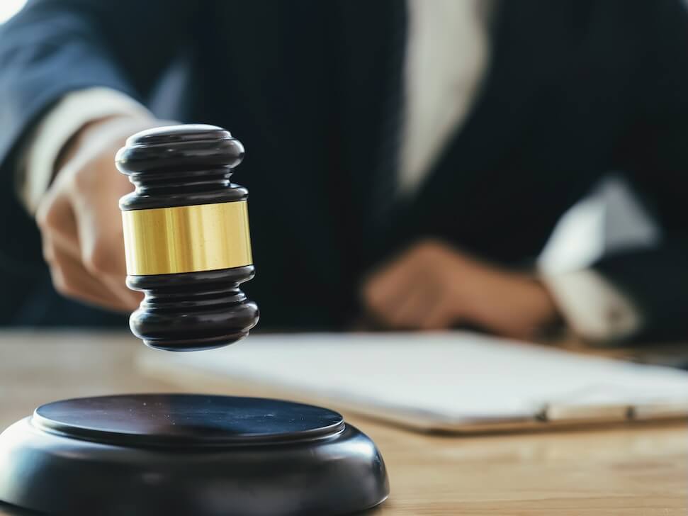 justice and lawfirm concept male lawyer in the office with brass scale