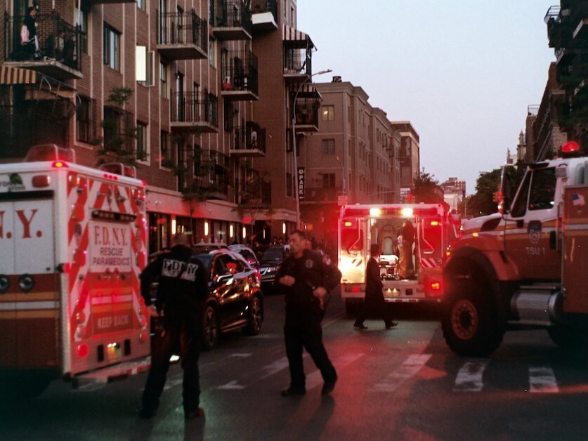 people walking on street near red and white bus during daytime