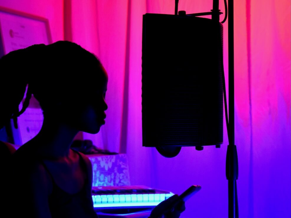 woman in black tank top standing near black microphone stand