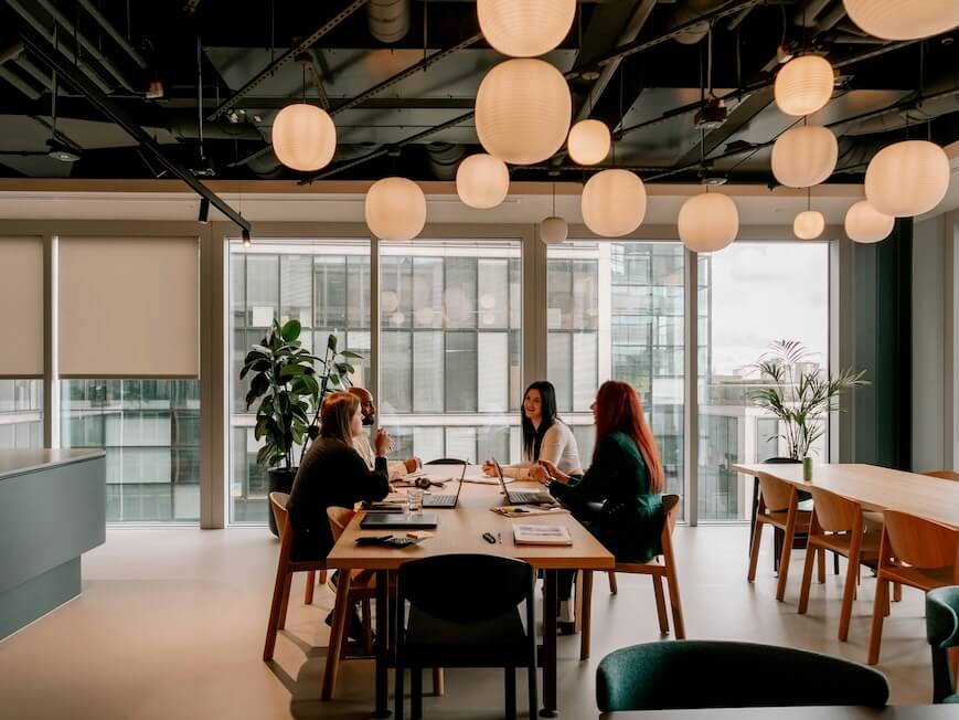 a group of people sitting around a table in a room