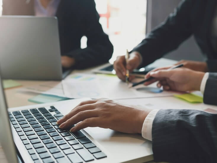 group of business people working together on new project with planning analytical report at meeting