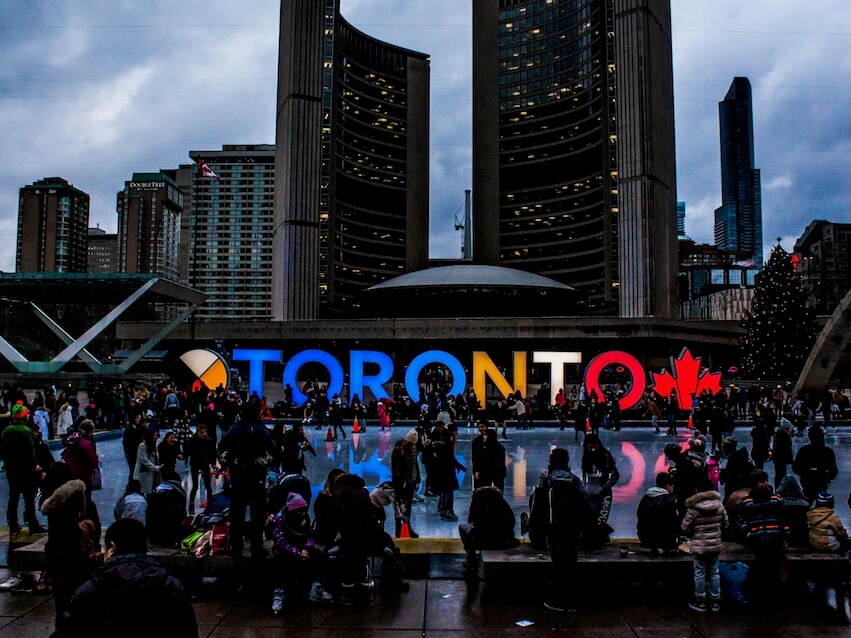 People Gathered in Front of Toronto Freestanding Signage