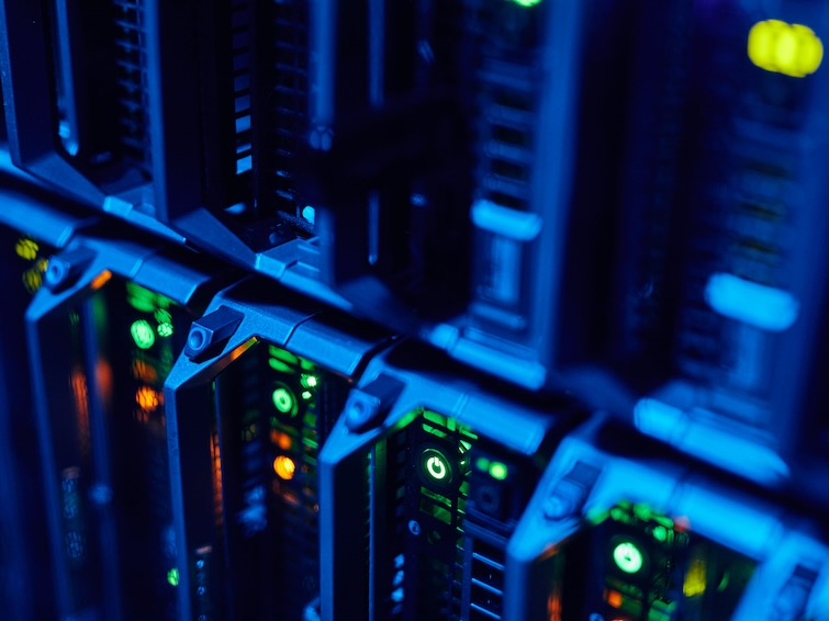 macro image of blade servers in blue neon light stacked in data center copy space