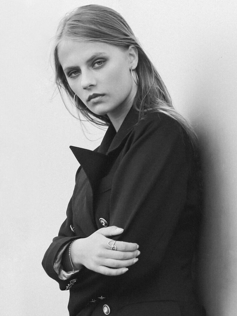 grayscaled photography of woman on wall