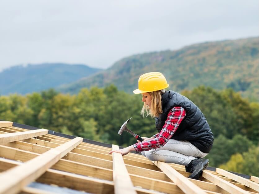 female worker on the building site young woman working as a roofer house construction