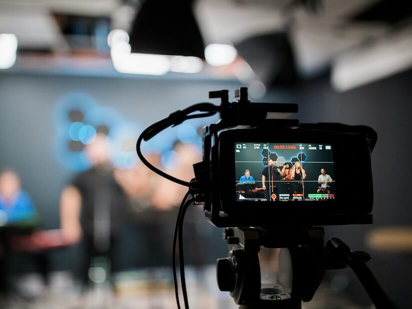 black dslr camera taking photo of city lights live stream