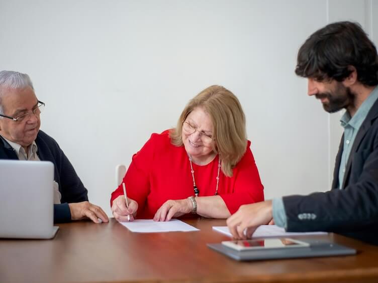 Woman Signing a Document in an Office