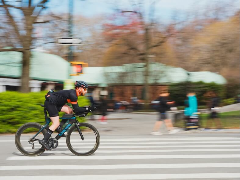 man in black riding e-bicycle on road during daytime
