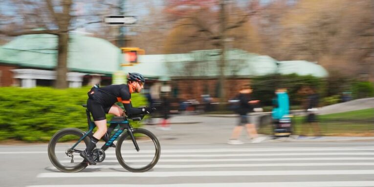 man in black riding e-bicycle on road during daytime FEATURED IMAGE
